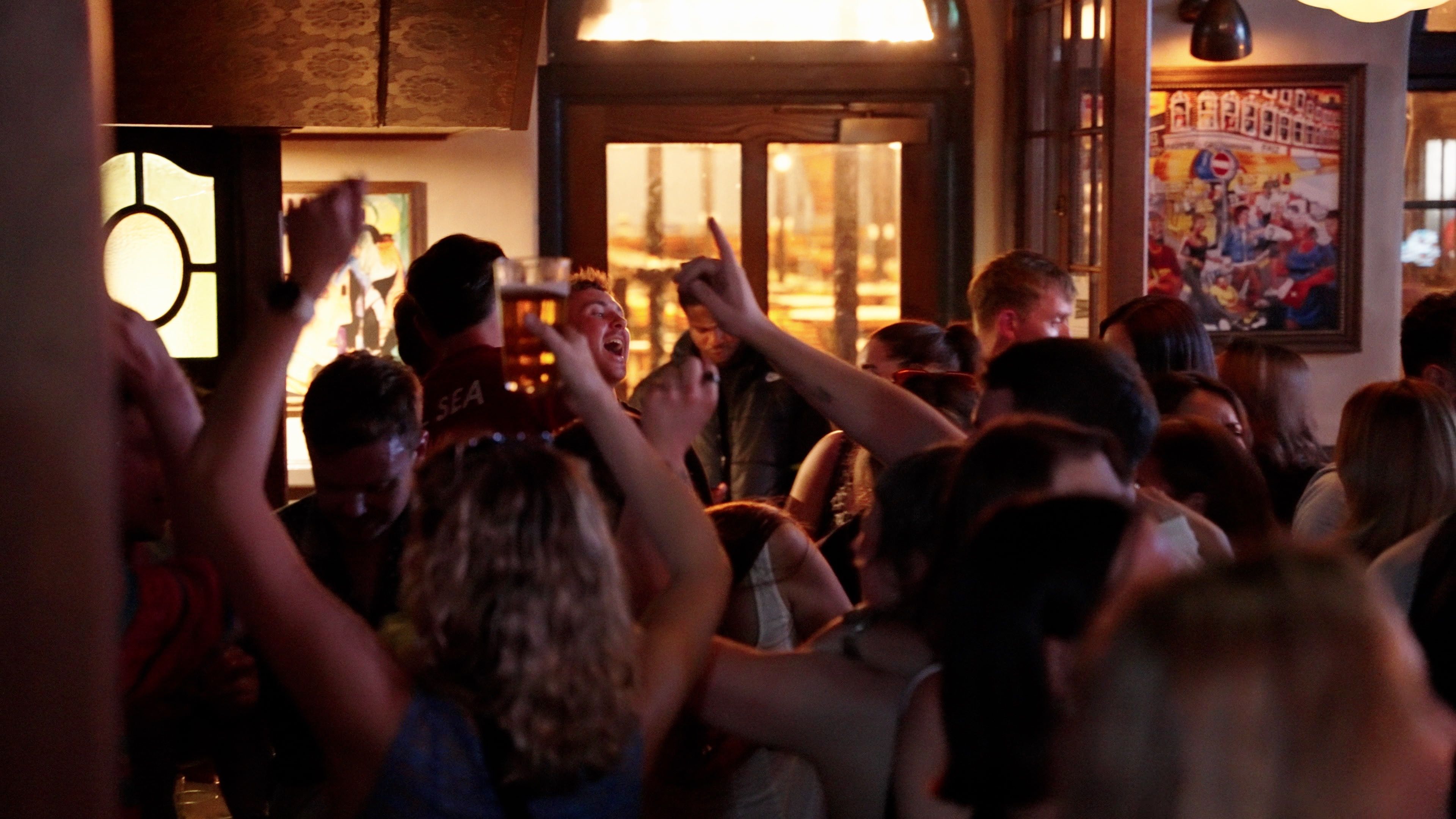 People enjoying drinks and celebrating after the England rugby match at The Hope & Anchor, Brixton.